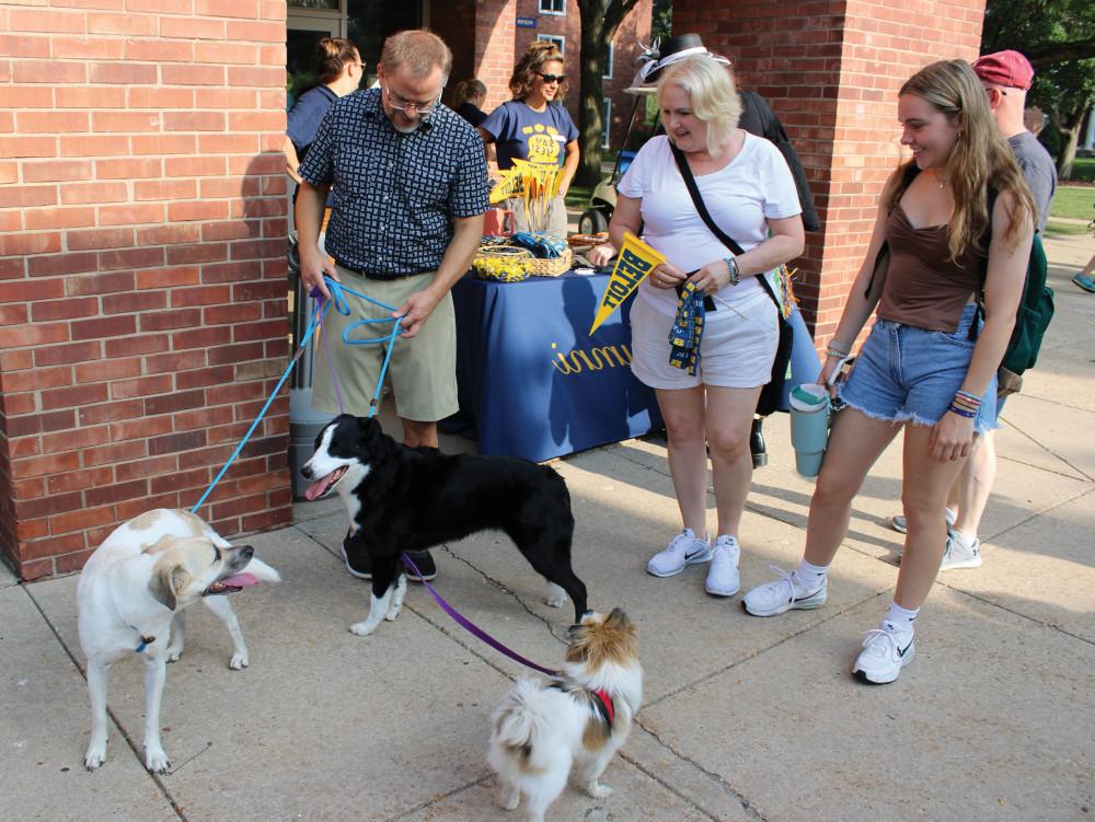 Eric and the pups on move-in day greeting students and their families.